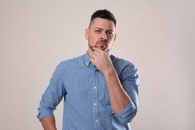 Photo of Emotional man in casual outfit on grey background