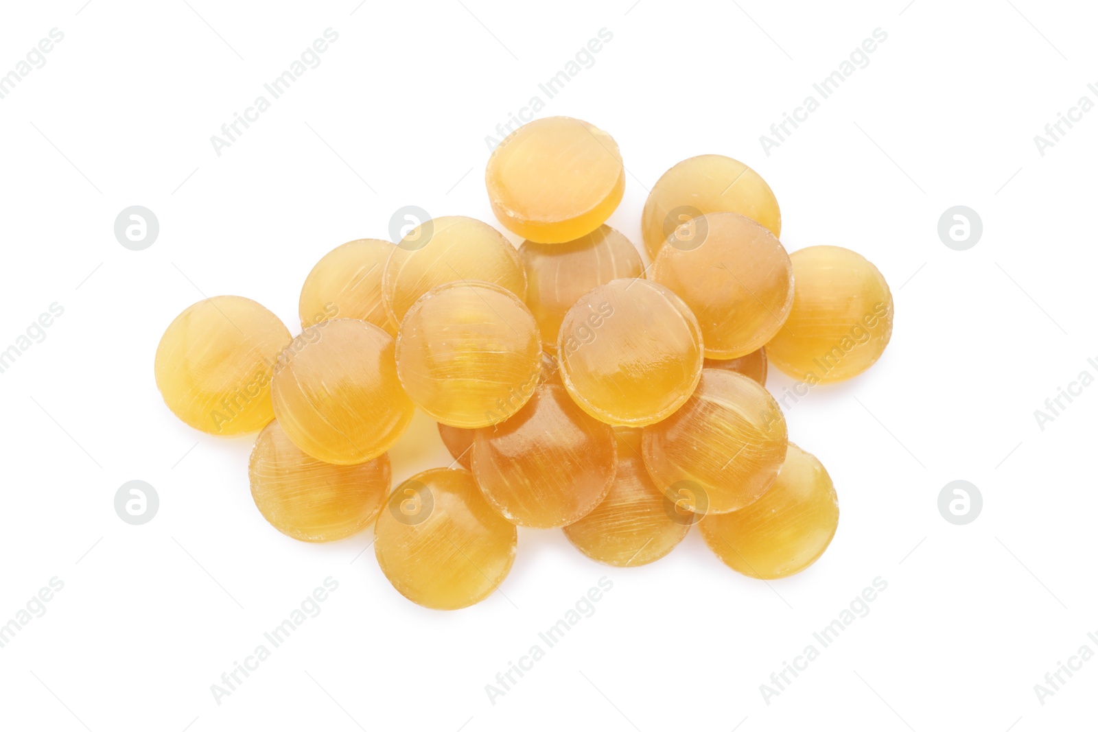 Photo of Many yellow cough drops on white background, top view