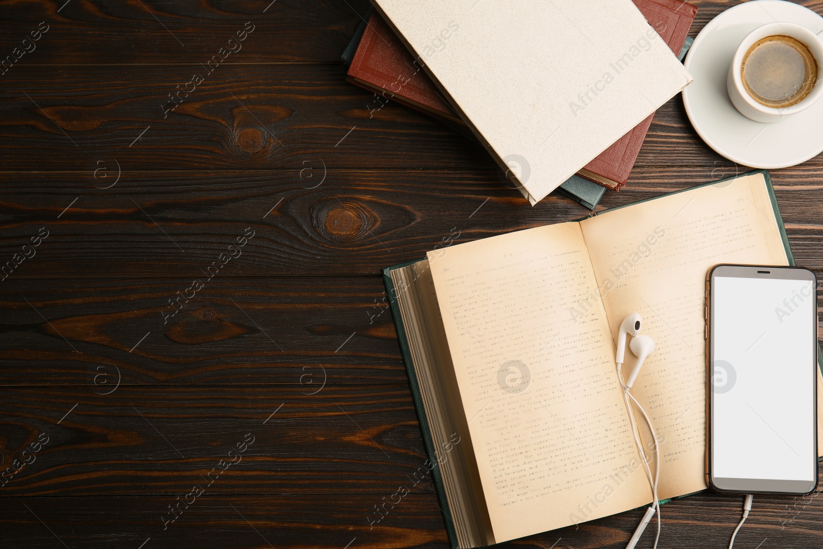 Photo of Books, coffee, earphones and mobile phone on wooden table, flat lay. Space for text