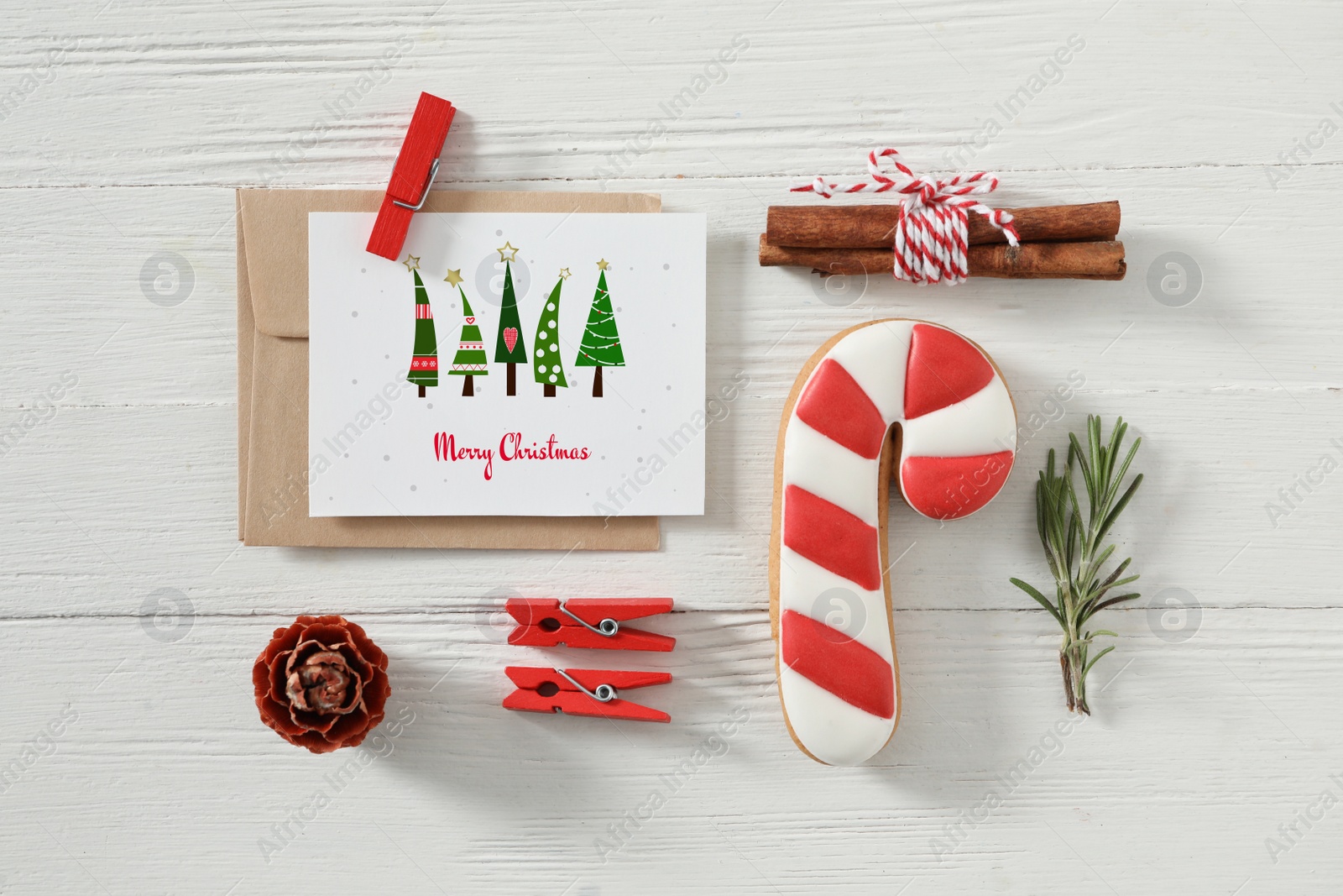 Image of Flat lay composition with greeting card on white wooden table. Merry Christmas