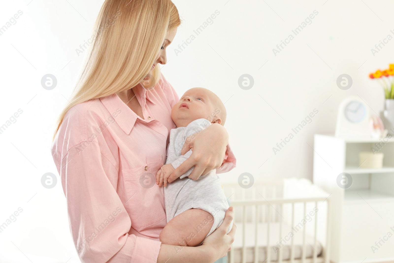 Photo of Happy mother and her baby at home