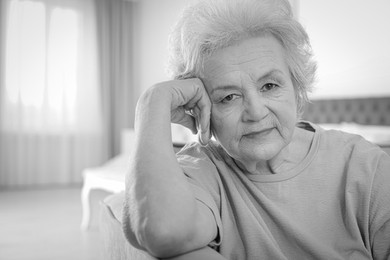 Image of Portrait of mature woman in living room. Black and white photography