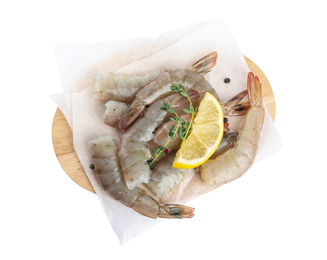 Wooden board with raw shrimps, lemon and thyme isolated on white, top view