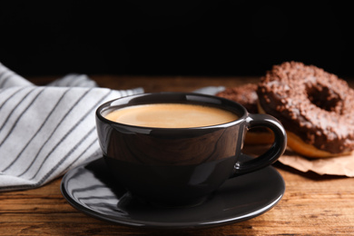 Photo of Delicious coffee and pastries on wooden table