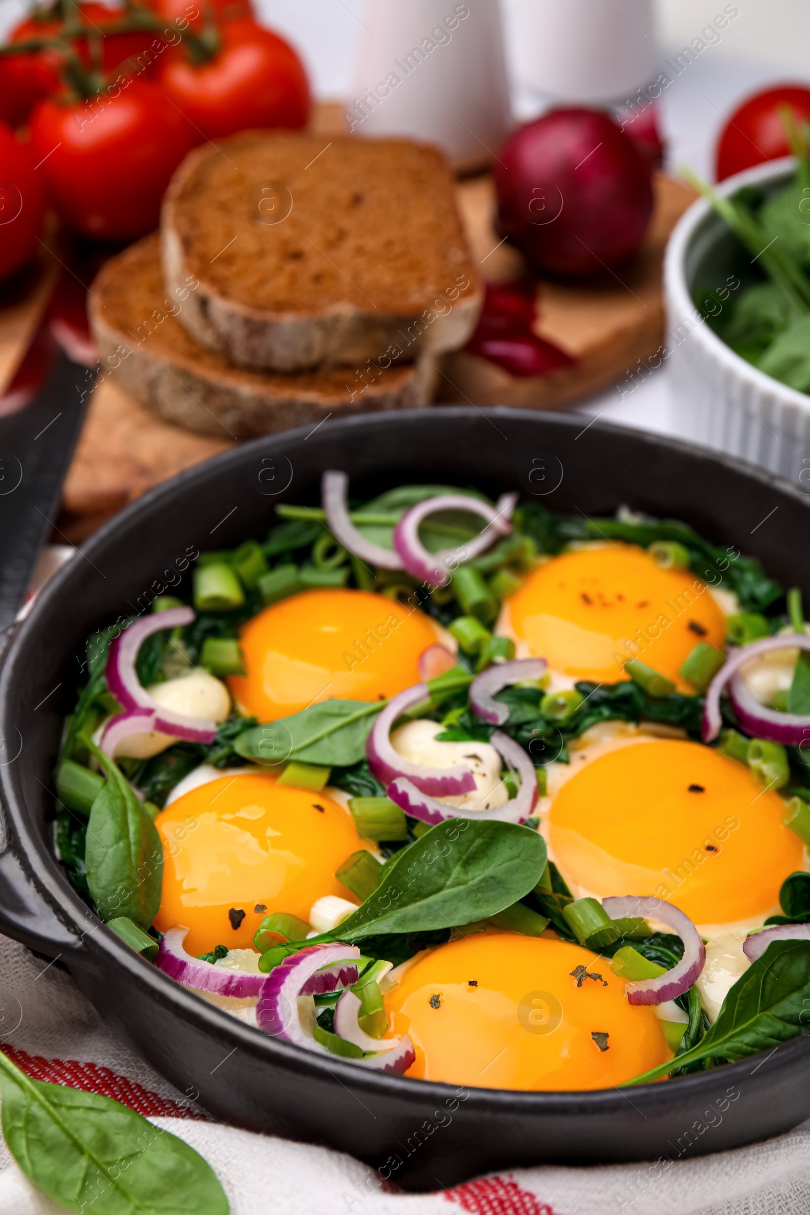 Photo of Tasty green Shakshouka served on table, closeup