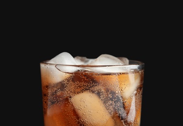 Photo of Glass of tasty refreshing cola with ice cubes on black background, closeup