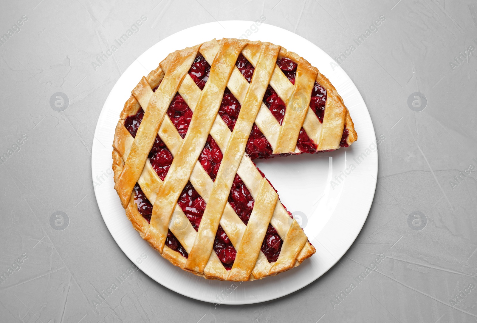 Photo of Delicious fresh cherry pie on light grey table, top view