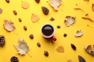 Photo of Flat lay composition with hot drink on yellow background. Cozy autumn