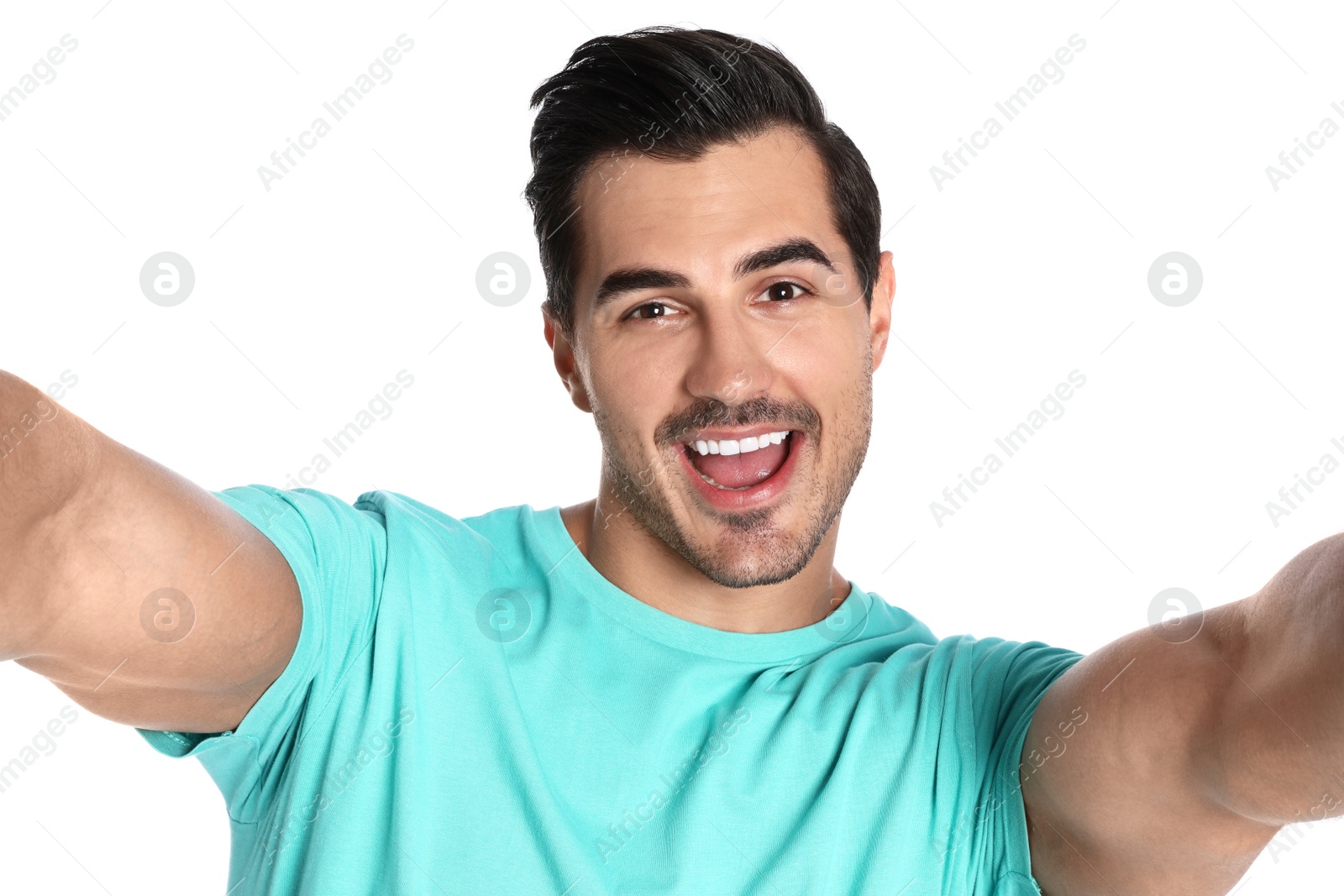 Photo of Happy young man taking selfie on white background