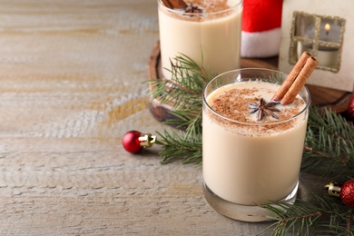 Delicious Christmas liqueur on wooden table. Space for text