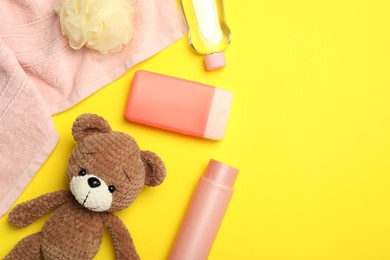 Photo of Flat lay composition with baby cosmetic products on yellow background, space for text