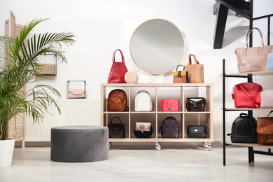Photo of Collection of stylish woman's bags in modern store