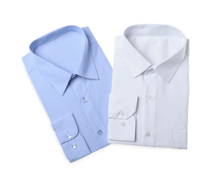 Photo of Stylish shirts isolated on white, top view. Dry-cleaning service