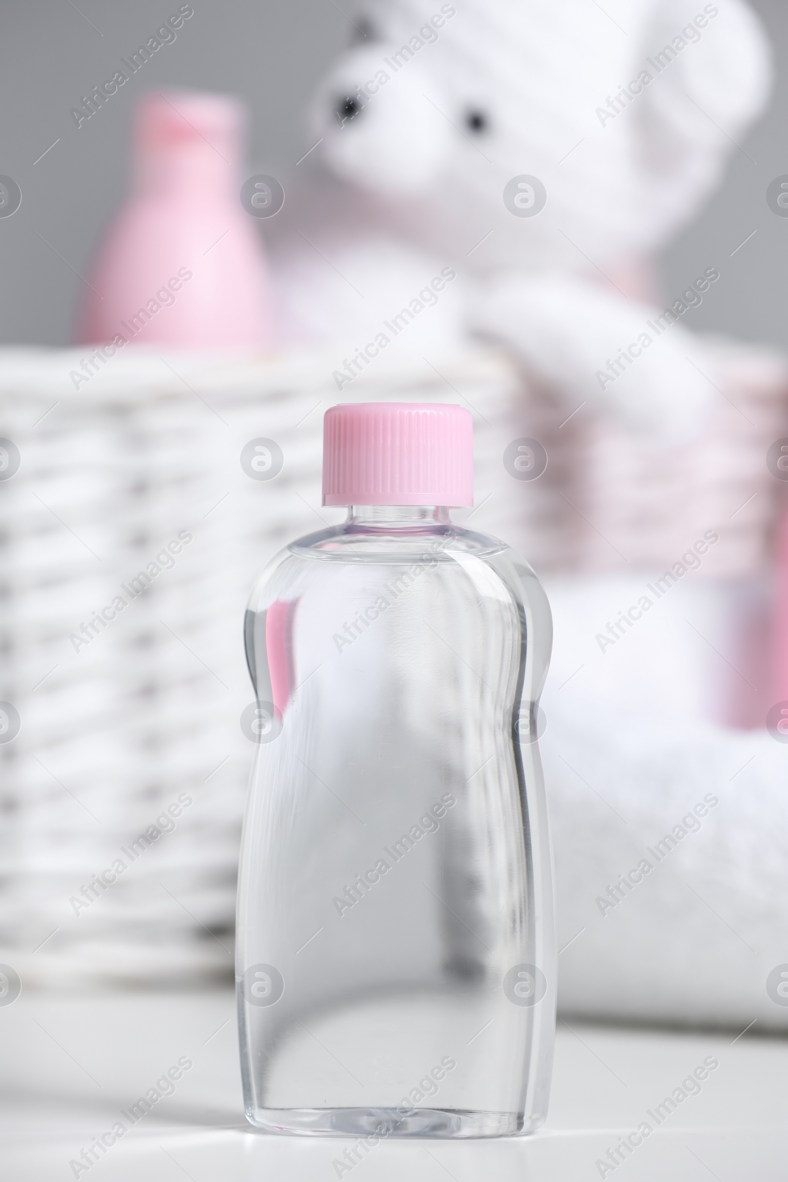 Photo of Bottle of baby cosmetic product on white table