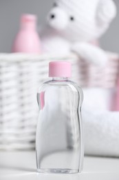 Photo of Bottle of baby cosmetic product on white table