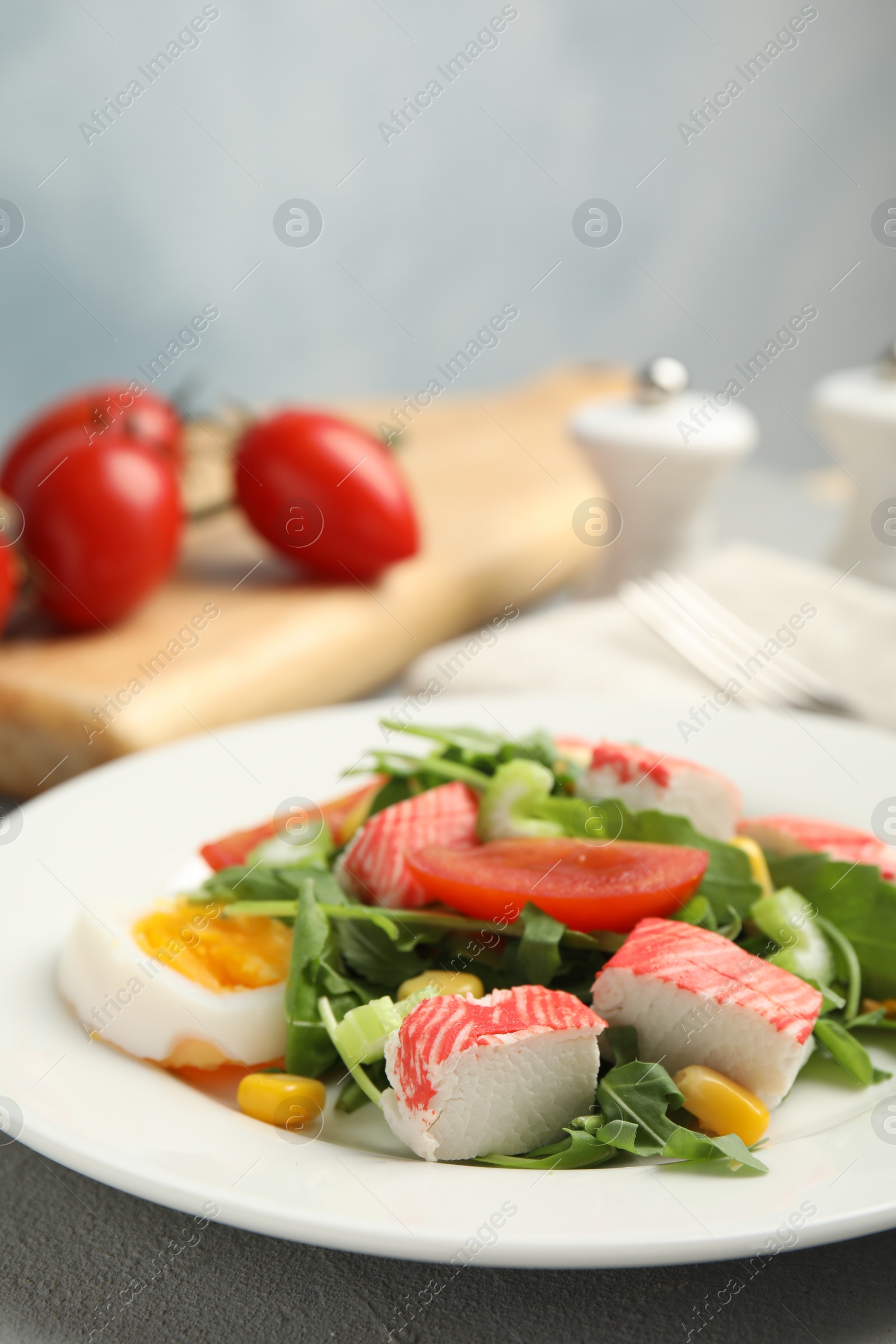 Photo of Delicious crab stick salad served on table, closeup