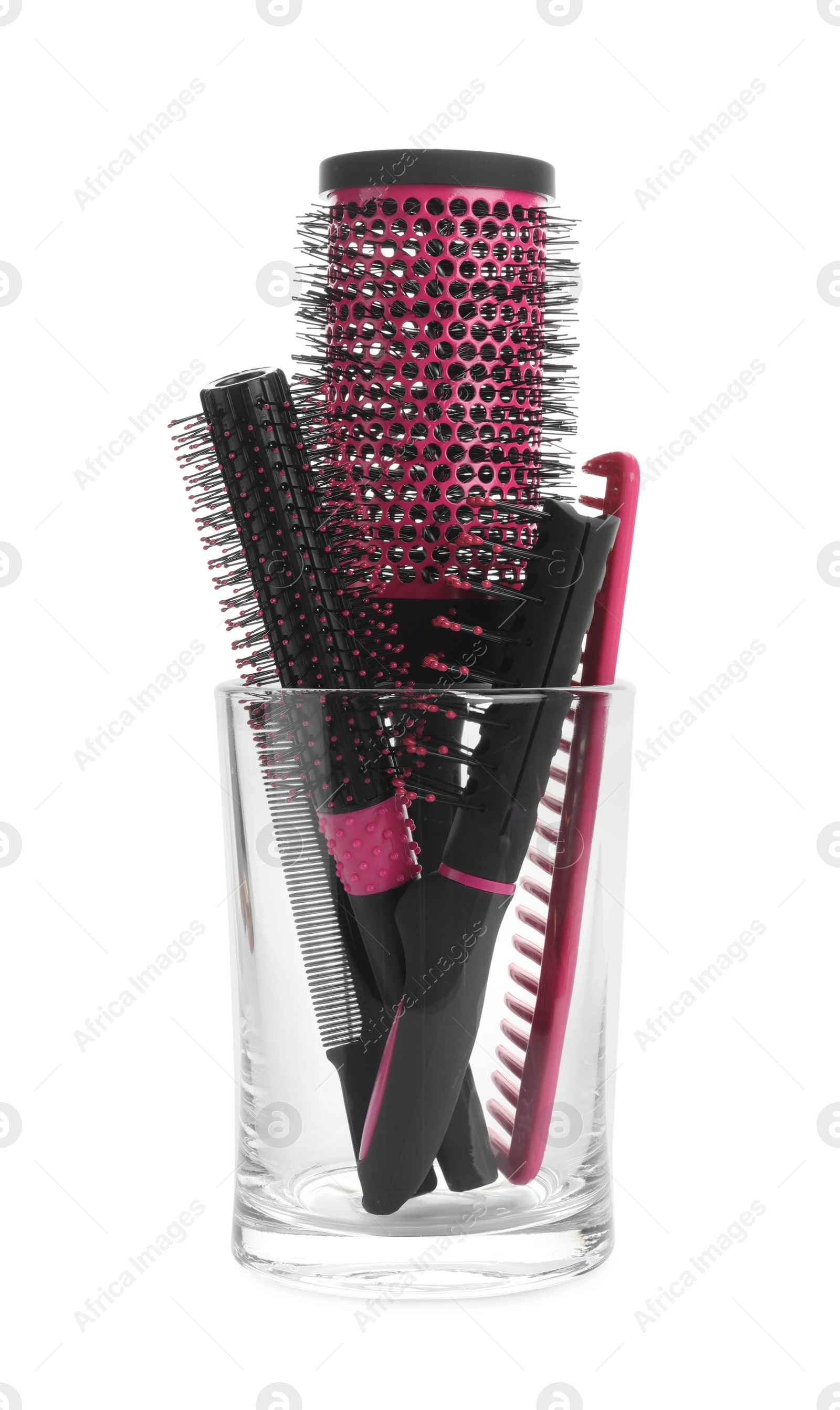 Photo of Set of professional hair brushes and combs in glass holder isolated on white