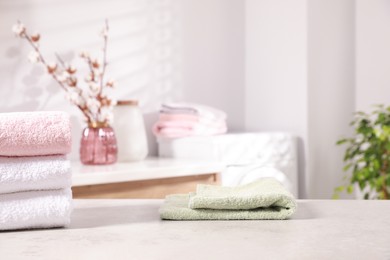 Different clean terry towels on table indoors