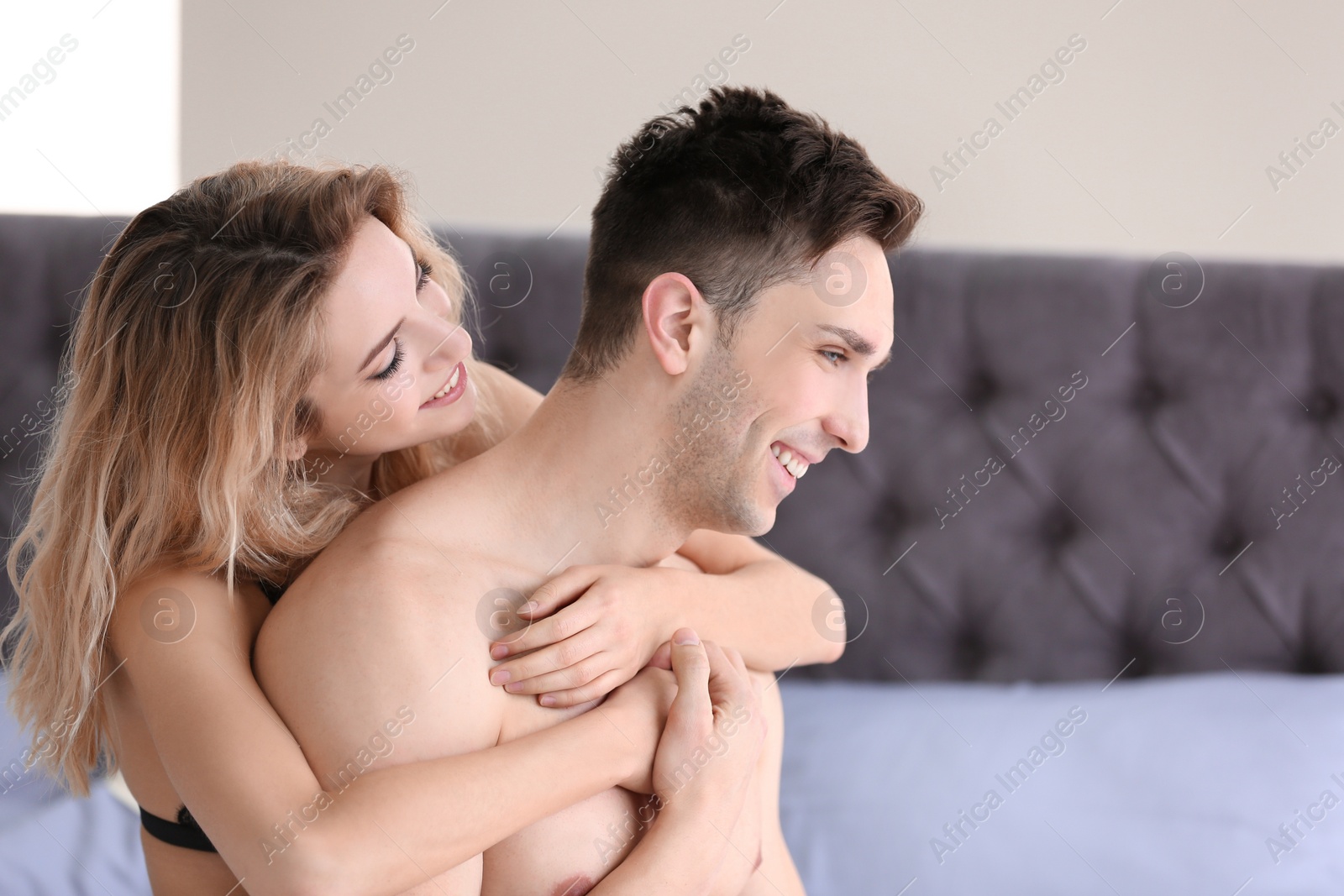 Photo of Sexy young couple being intimate on bed at home