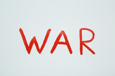 Photo of Word War written with red paint on white background, top view