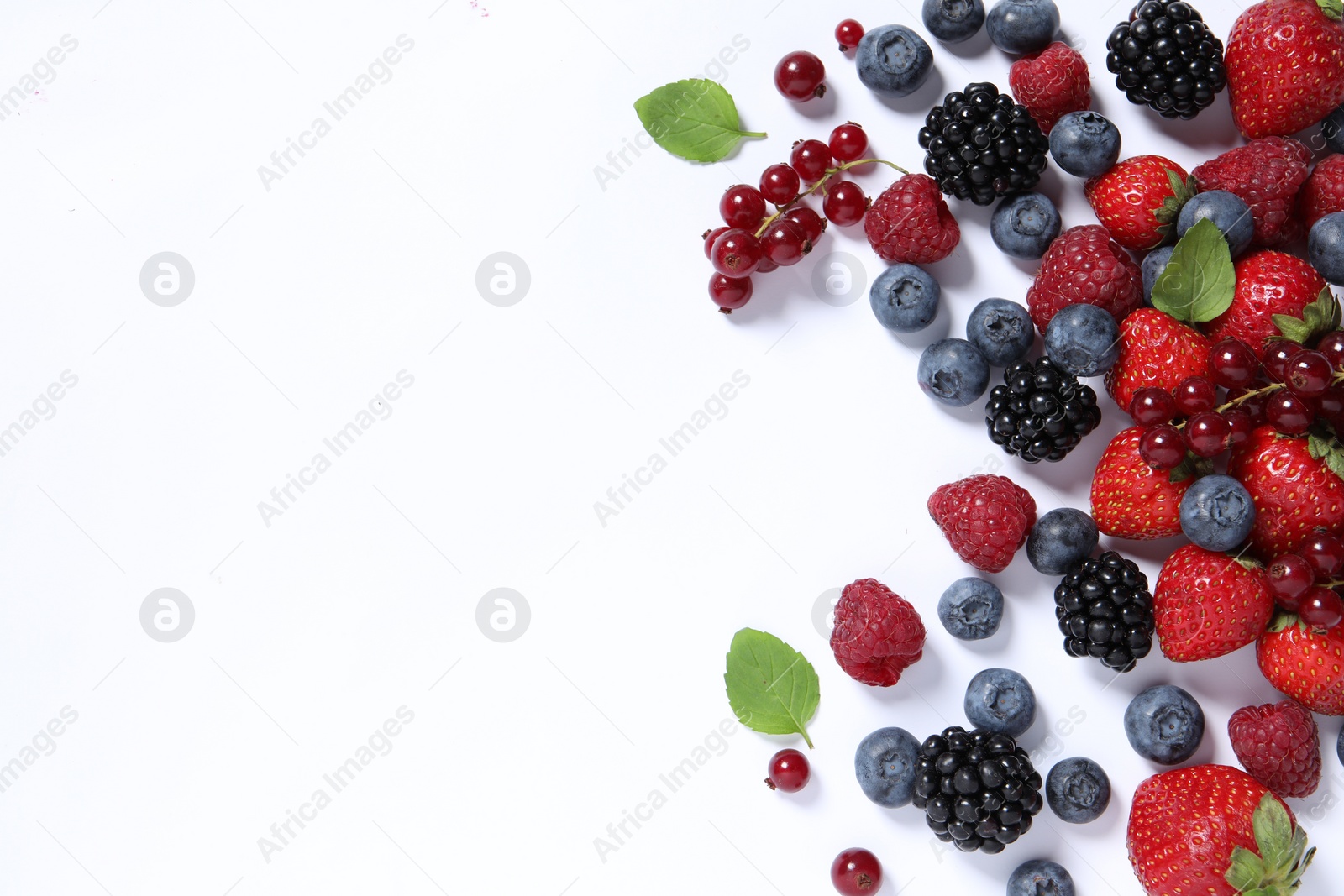 Photo of Many different fresh berries and mint leaves on white background, flat lay. Space for text