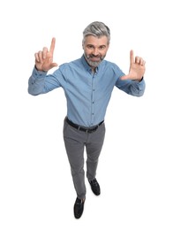 Mature businessman in stylish clothes posing on white background, above view