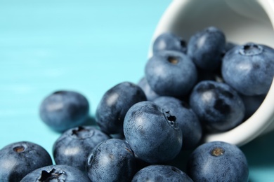 Photo of Juicy and fresh blueberries on wooden table, closeup