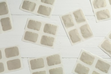 Photo of Mustard plasters on white wooden table, flat lay