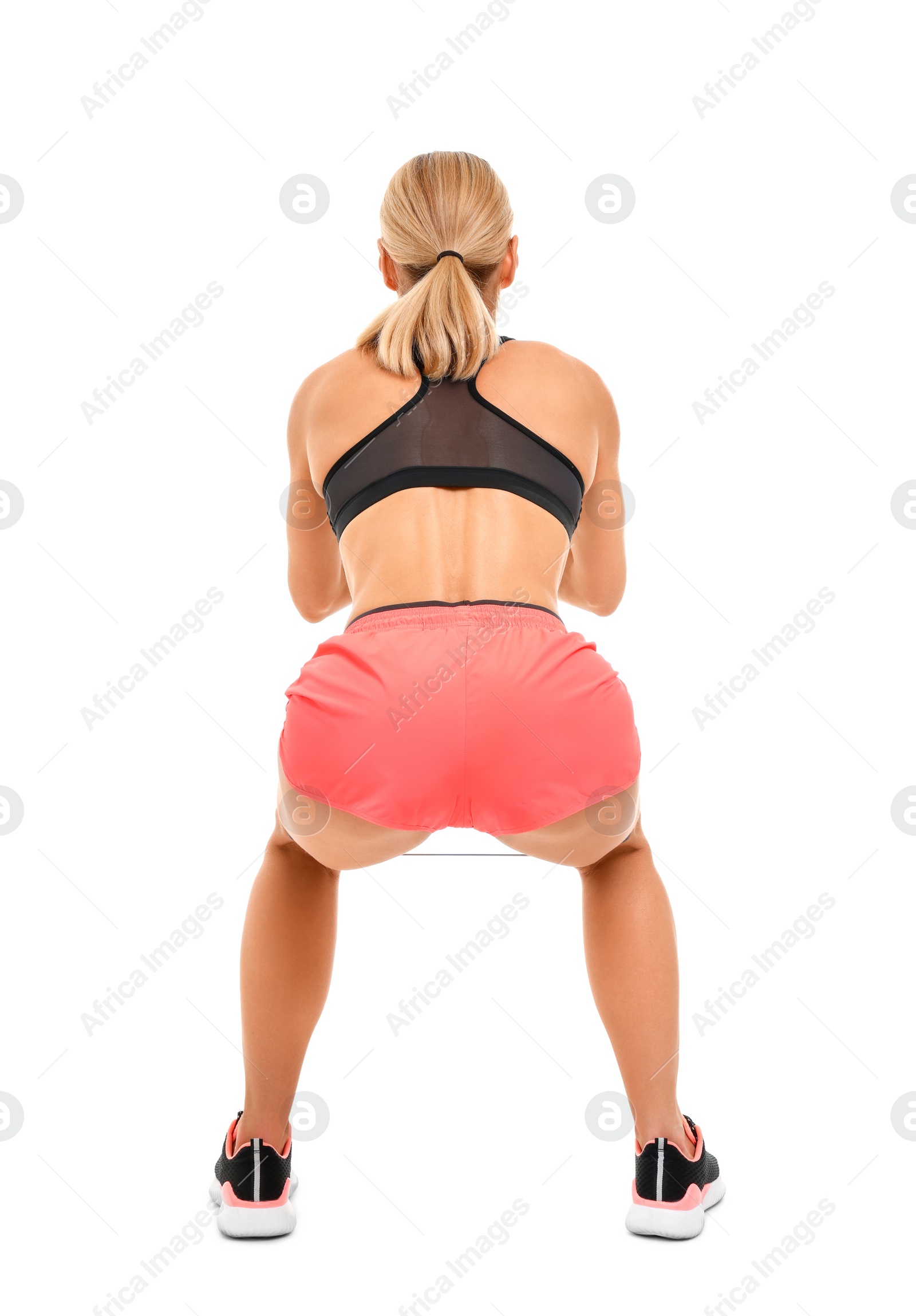 Photo of Woman exercising with elastic resistance band on white background, back view