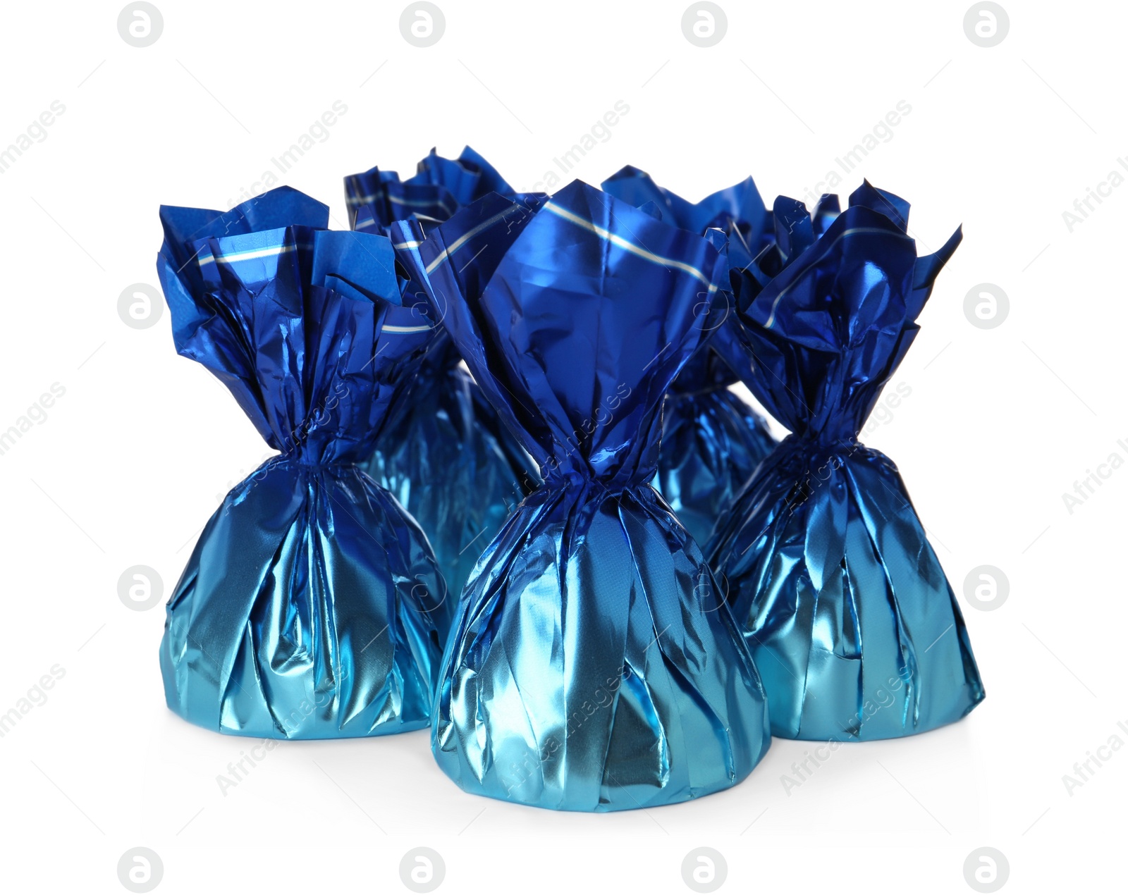 Photo of Delicious candies in blue wrappers on white background