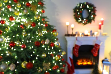 Photo of Blurred view of decorated room with Christmas tree and fireplace