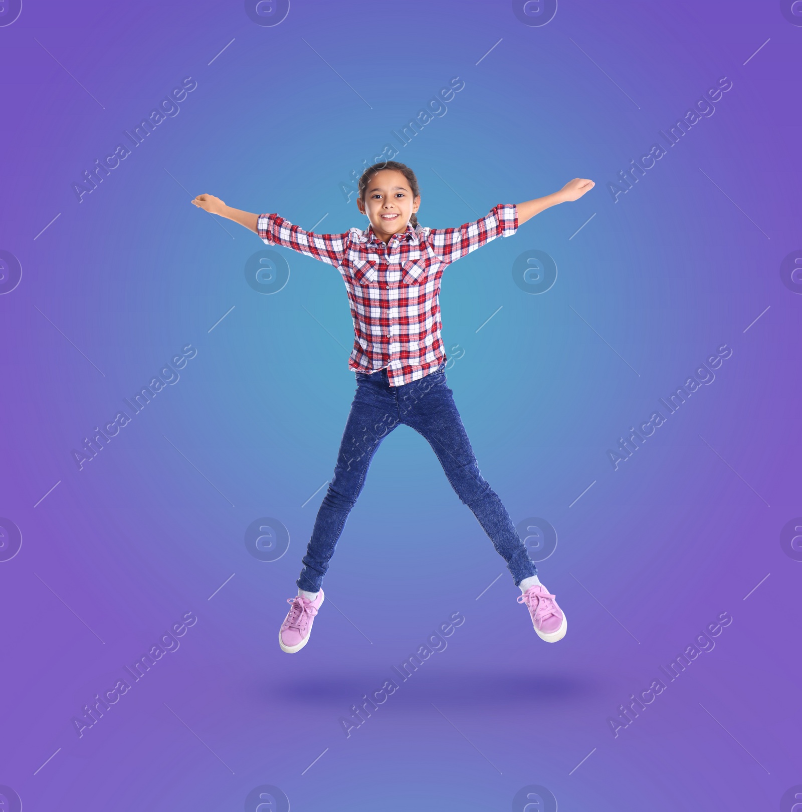 Image of Happy cute girl jumping on color gradient background