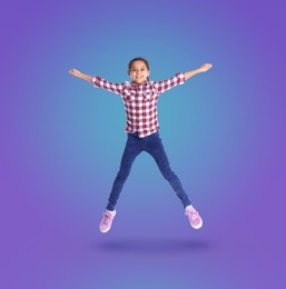 Happy cute girl jumping on color gradient background