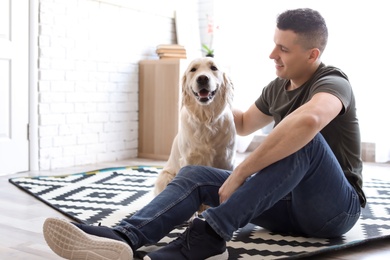 Portrait of owner with his friendly dog at home