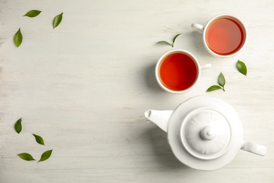 Flat lay composition with delicious tea on wooden background