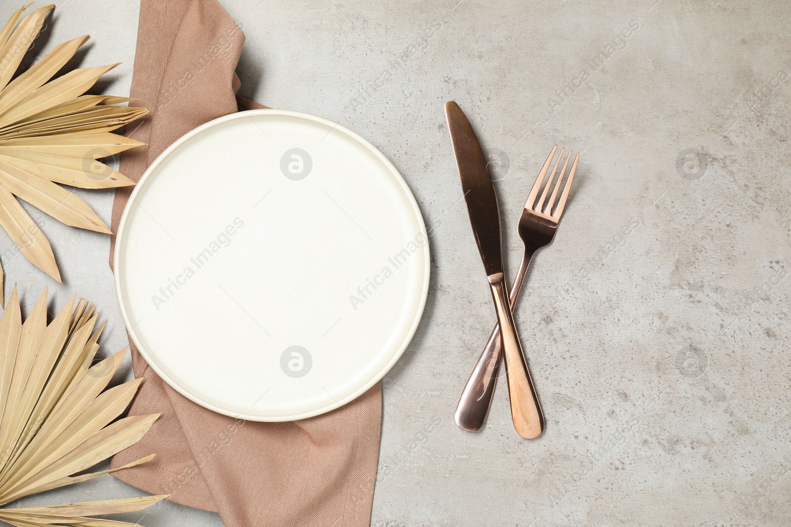 Photo of Setting with beautiful cutlery on textured table, top view