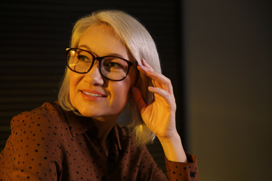 Beautiful mature woman in glasses at home