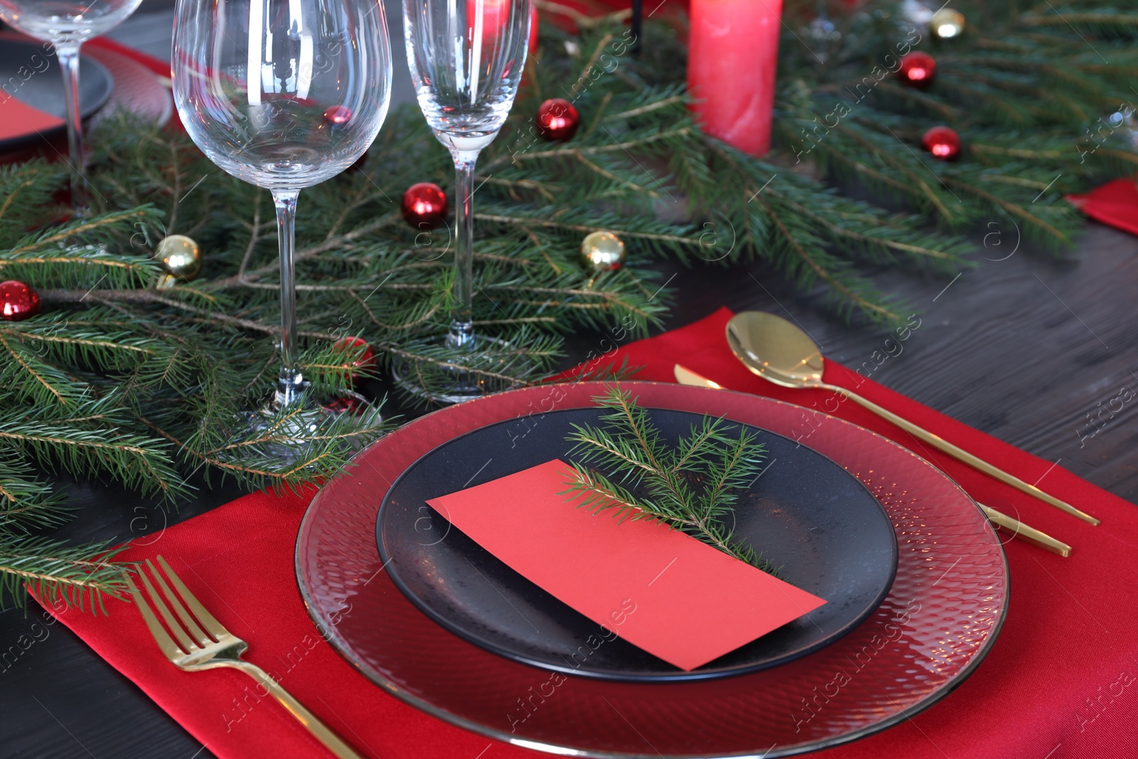 Photo of Elegant Christmas place setting with blank card and festive decor on table