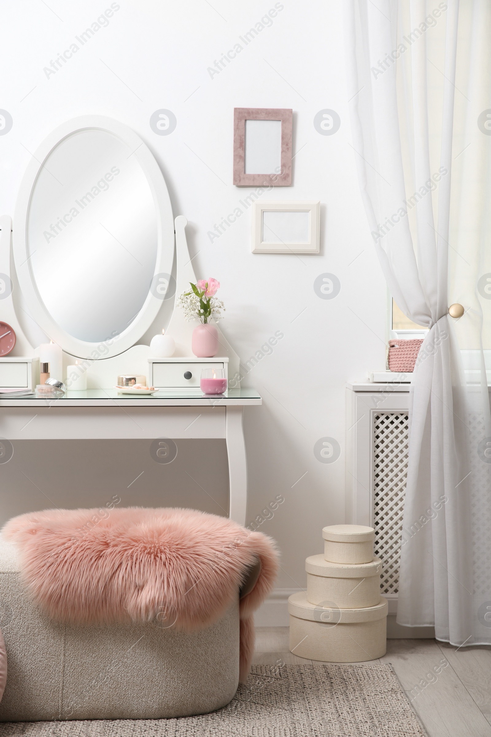 Photo of Dressing table with decor near white wall in room