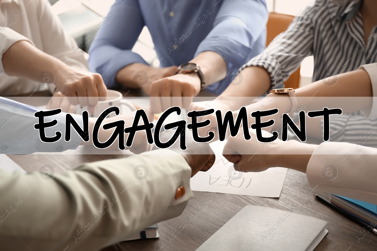 Image of Engagement concept. People holding fists together over table, closeup