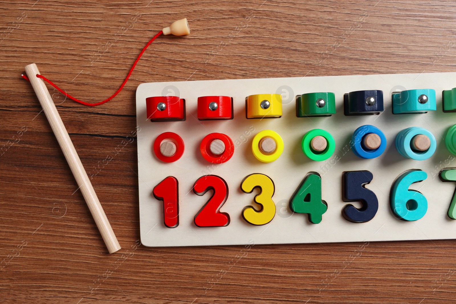 Photo of Math game Fishing for Numbers on wooden table, flat lay