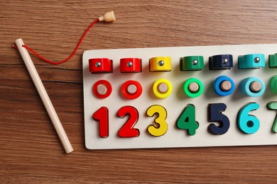 Photo of Math game Fishing for Numbers on wooden table, flat lay