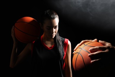 Image of Basketball players with leather balls on black background, collage