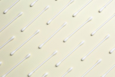 Photo of Many cotton buds on beige background, flat lay