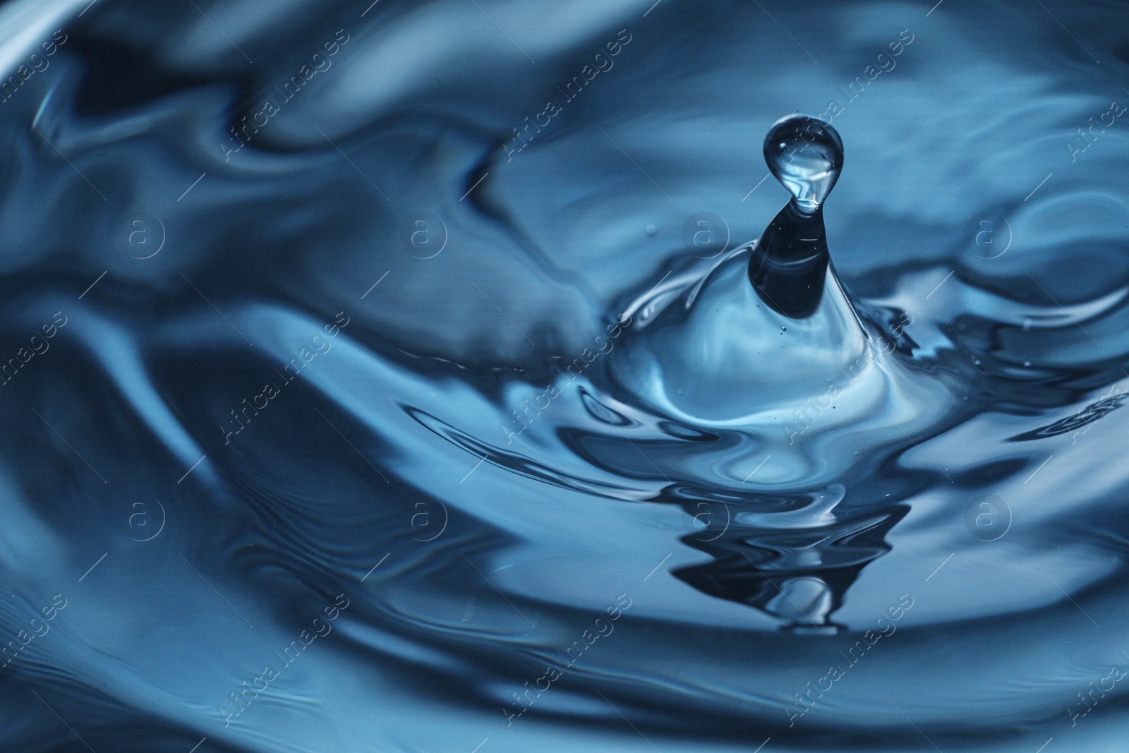 Photo of Splash of clear water with drop, closeup