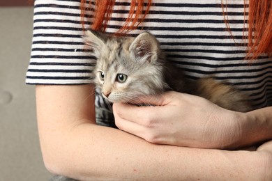 Photo of Woman with cute fluffy kitten, closeup view