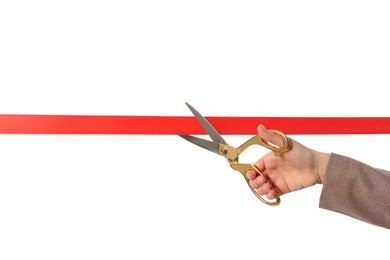 Woman in office suit cutting red ribbon isolated on white, closeup