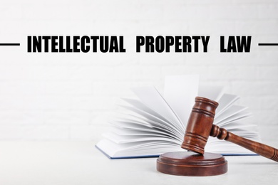 Image of Text Intellectual Property Law over judge's gavel and book on table