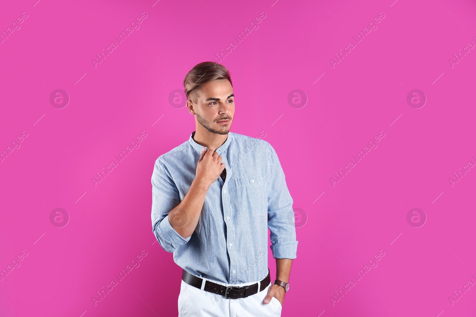 Photo of Young man with trendy hairstyle on color background