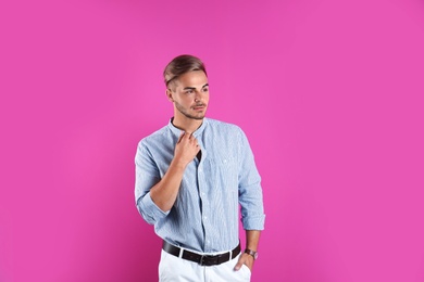 Photo of Young man with trendy hairstyle on color background